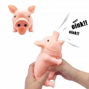 A pig toy shouts at a click to play for a dog